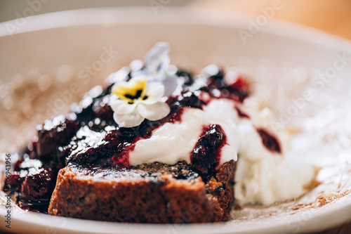 Sweet toast from homemade banana bread, non dairy yogurt and fresh berries compote