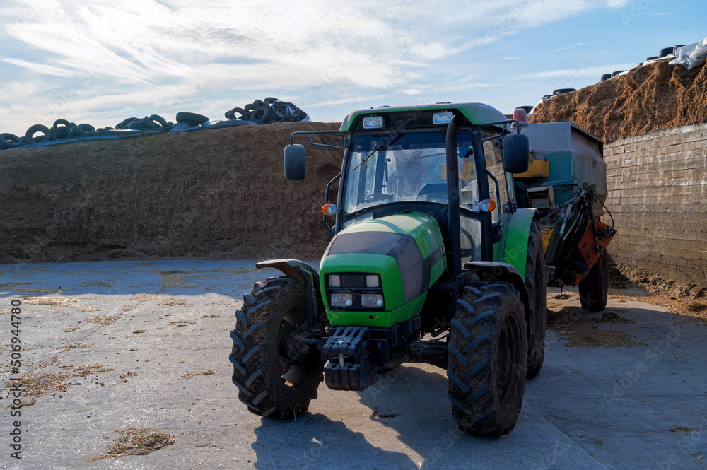 Obraz premium Tracror with attached forage cutting machine for animals