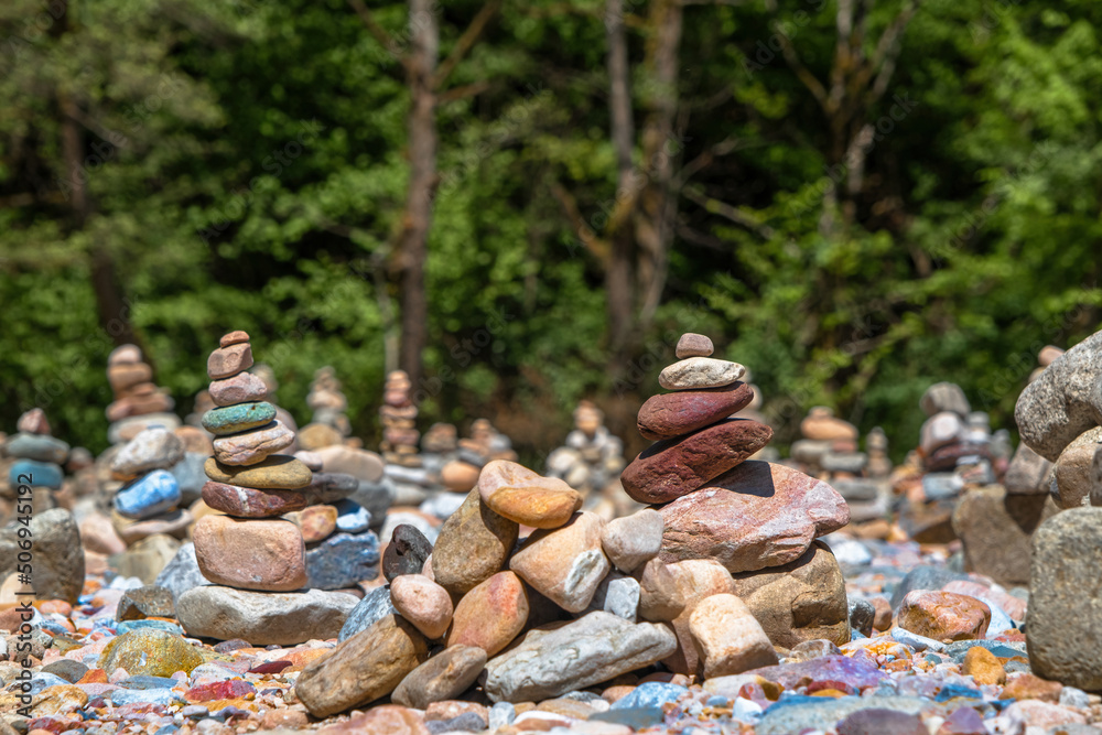 stones laid in a pyramid on the river bank near the forest stones laid in a pyramid on the river bank near the forest