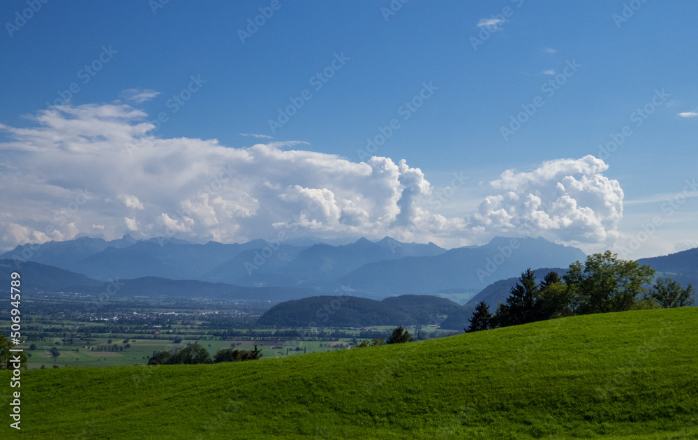 Sunny mountain landscape with blue sky and white clouds