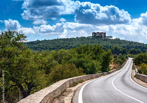 Фотография Castel del Monte against the blue sky with white clouds