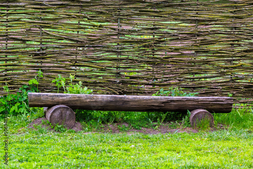 horizontal wattle fence with wooden bench near at summer day in Yasnaya Polyana, Russia photo