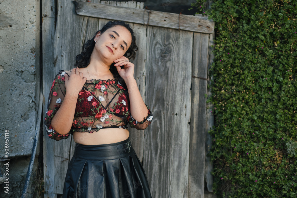 Fototapeta premium Sexy Latina poses in a sheer top and black skirt