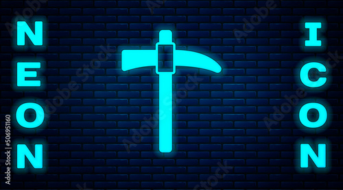 Glowing neon Pickaxe icon isolated on brick wall background. Vector