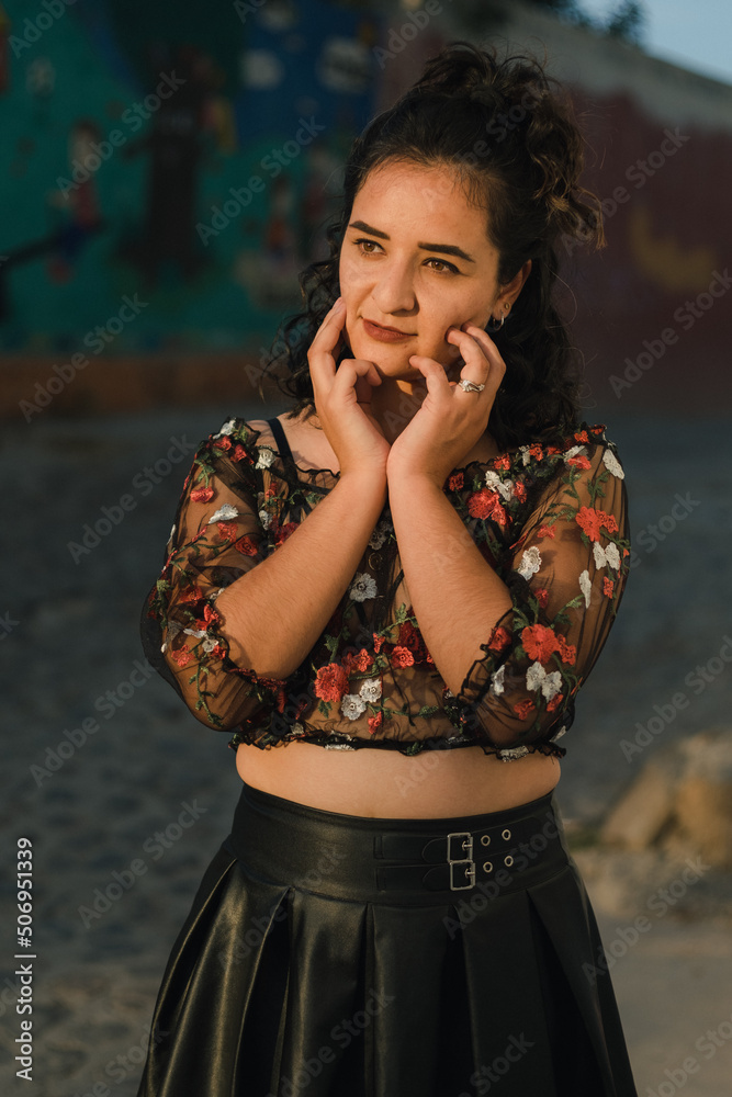 Obraz premium Pretty Latina poses in a see-thru top with a red bra