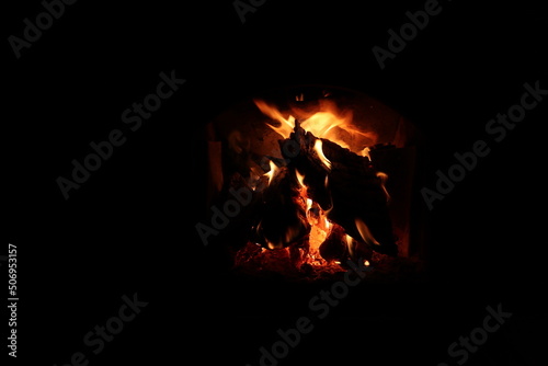 burning logs in the fireplace in the dark
