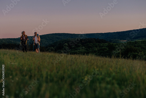 Middle aged couple on vacation hiking at sunrise