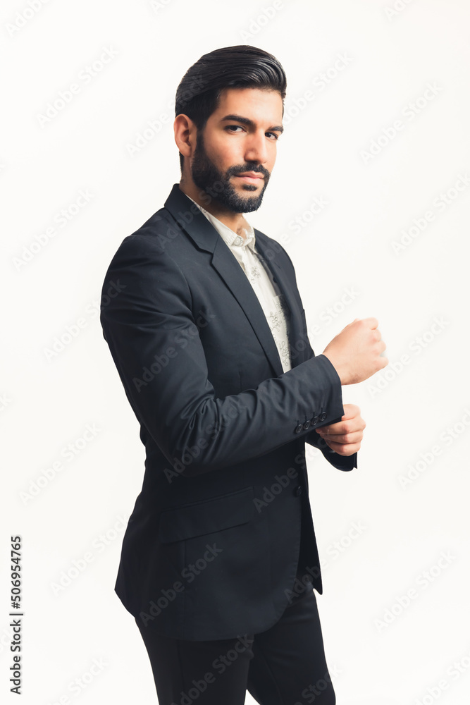 Attractive Latin man wearing a suit fastering a button and looking at the camera vertical shot, isolated white background. High quality photo Attractive Latin man wearing a suit fastering a button and looking at the camera vertical shot, isolated white background. High quality photo