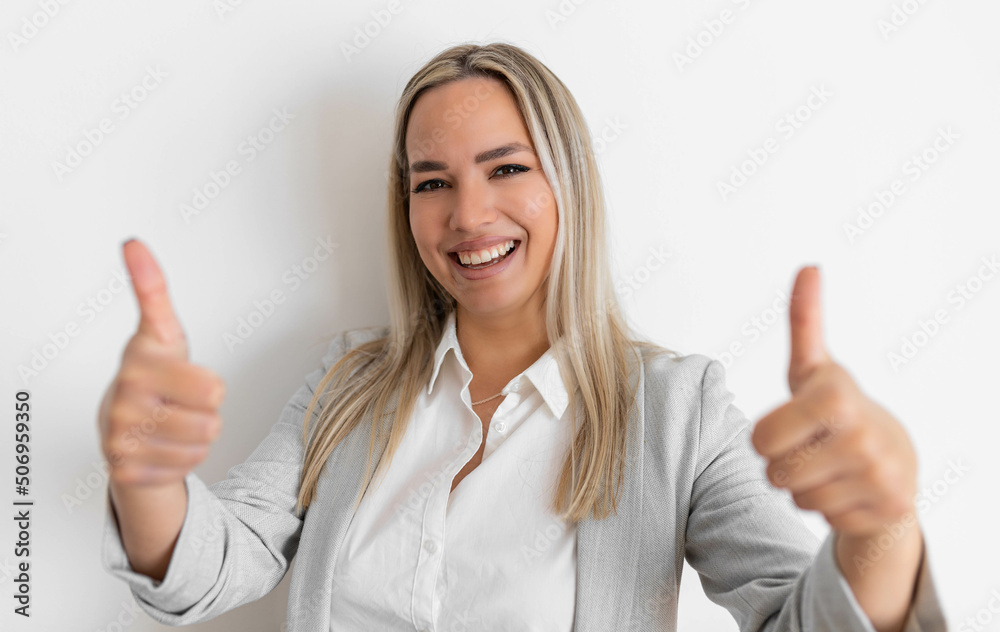 Smiling professional doctor in medical uniform shows thumbs up. Pleased female physician smiling, recommending product, white background Smiling professional doctor in medical uniform shows thumbs up. Pleased female physician smiling, recommending product, white background