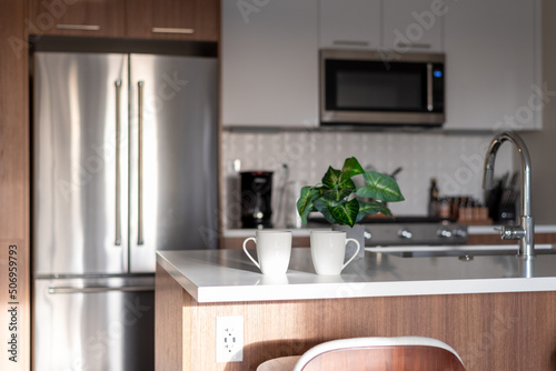 Two cups of coffee on the kitchen counter in a clean stylish apartment