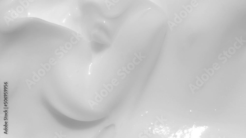 White cream, shampoo texture, sunscreen cosmetic smear background video. Moisturising beauty creme swatch motion with spatula. Creamy skincare lotion mousse product closeup footage. Macro photo