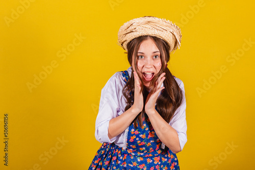 Woman wearing typical clothes for the Festa Junina. Amazed, overjoyed, elated. photo