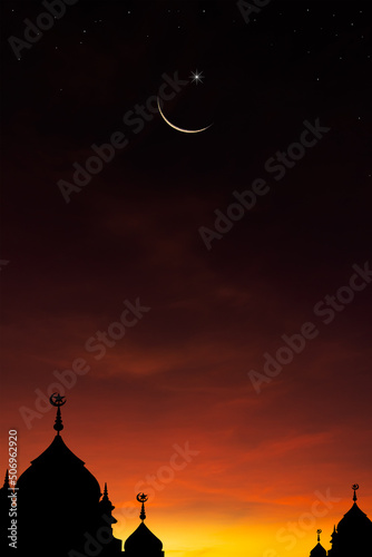 Crescent moon on dusk sky on twilight in the evening over dome mosques vertical with symbol of religion Islamic and free space for text Eid Al Adha  Muharram  