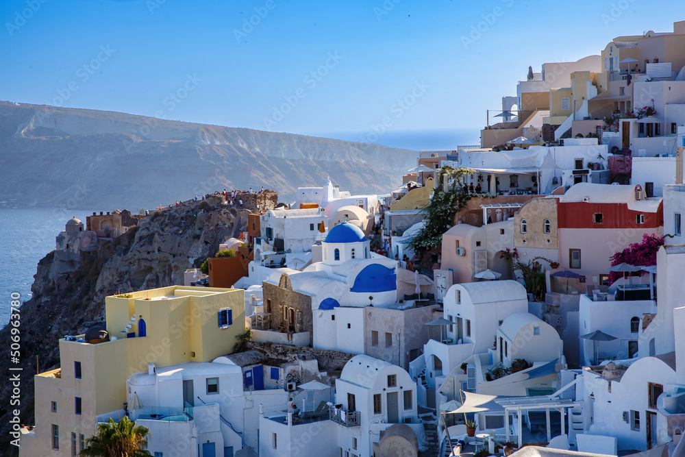 Village with greek white architecture on the sea cliff. Oia streets on Santorini, Greece.