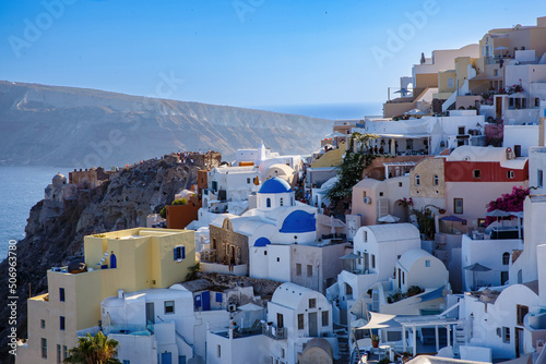 Fototapeta Naklejka Na Ścianę i Meble -  Village with greek white architecture on the sea cliff. Oia streets on Santorini, Greece.