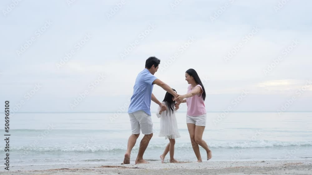 Holiday concept of 4k Resolution. Asian parents and daughters having fun at the beach. summer vacation travel. Holiday concept of 4k Resolution. Asian parents and daughters having fun at the beach. summer vacation travel.