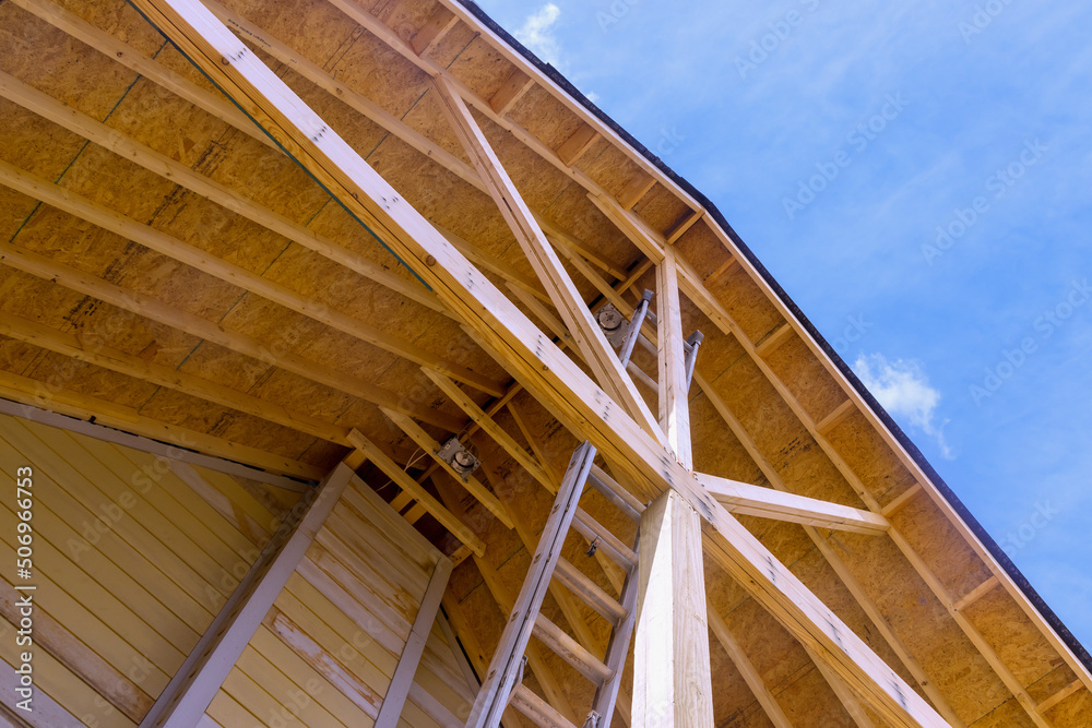 Fototapeta premium New wooden roof under construction visor the porch for house