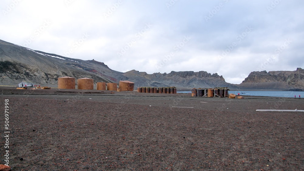 Row of rusted whale oil tanks and boilers used to rend whale oil at Whaler's Bay, on Deception Island, Antarctica