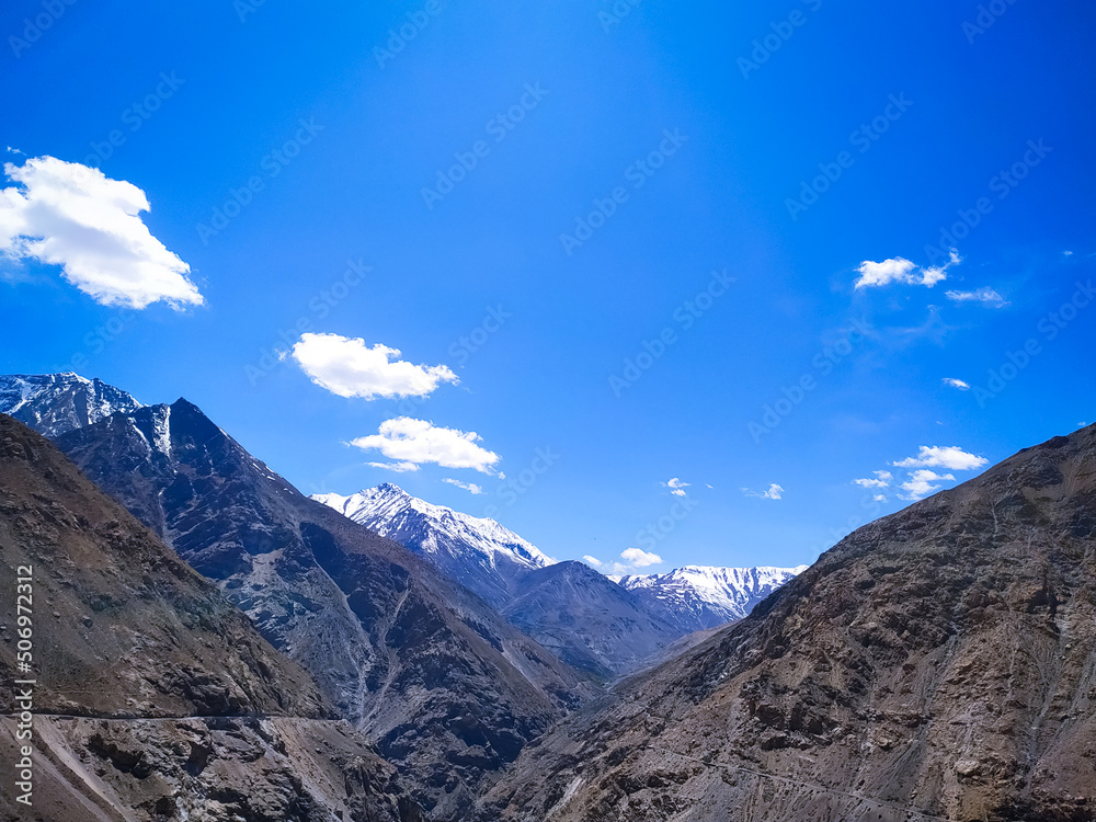 Scenic view of Spiti Valley with snow covered mountain blue sky and clouds  Himachal Pradesh, India.