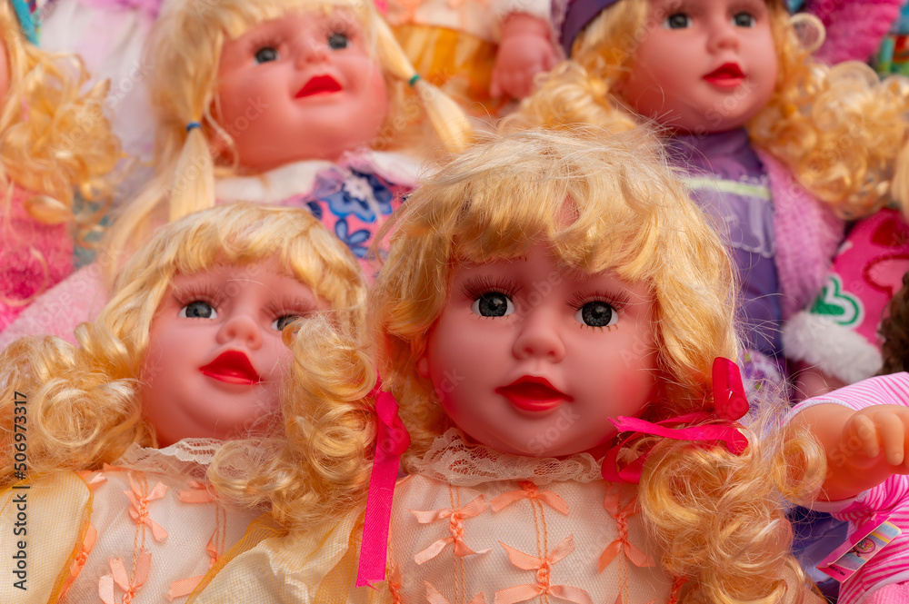 Colourful tiny blonde baby dolls for sale at retail shop at Christmas market, New Market area, Kolkata, West Bengal, India. Colourful tiny blonde baby dolls for sale at retail shop at Christmas market, New Market area, Kolkata, West Bengal, India.