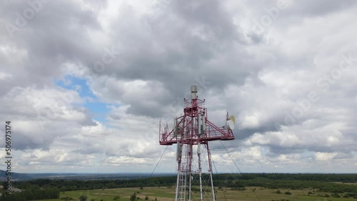Aerial view of telecommunications cell phone tower with wireless communication antennas for network signal transmission