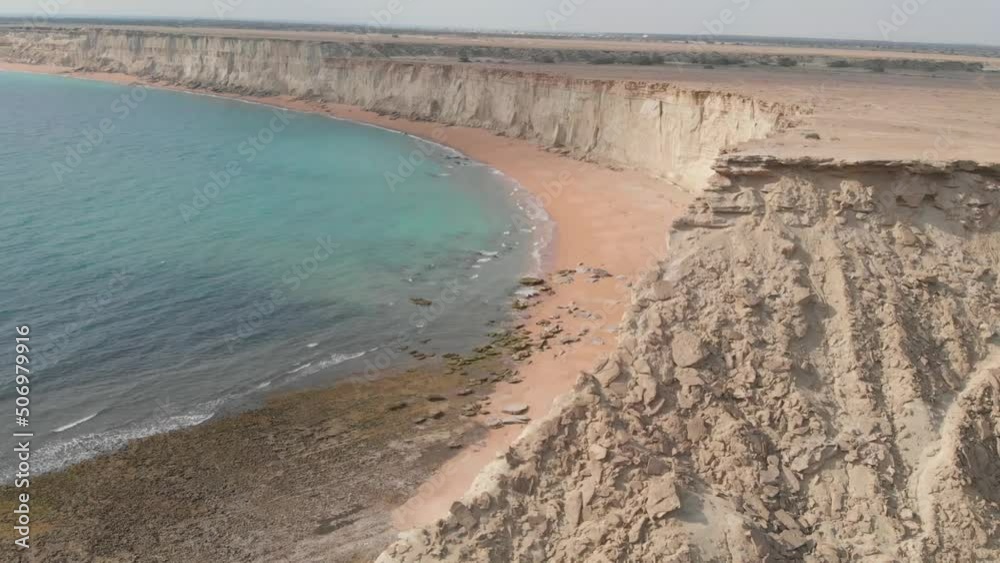 Aerial View Of Arid Desert Cliffs Beside Jiwani beach In Gwadar District of the Balochistan. Dolly Back Rising Aerial View Of Arid Desert Cliffs Beside Jiwani beach In Gwadar District of the Balochistan. Dolly Back Rising