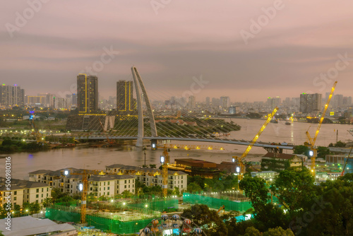 Aerial view of Bitexco Tower  buildings  roads  Thu Thiem 2 bridge and Saigon river in Ho Chi Minh city - Far away is Landmark 81 skyscraper. Travel concept.