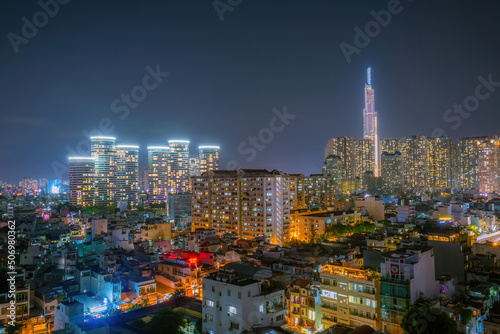 Aerial view of Bitexco Tower, buildings, roads, Thu Thiem 2 bridge and Saigon river in Ho Chi Minh city - Far away is Landmark 81 skyscraper. Travel concept.