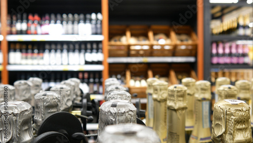 Many expensive bottles of wine and champagne on the shelves of an alcohol store