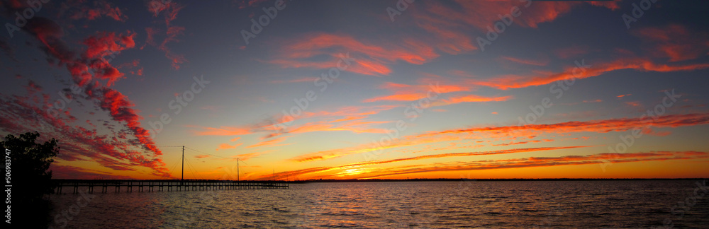 Fototapeta premium River sunset clouds dock panorama