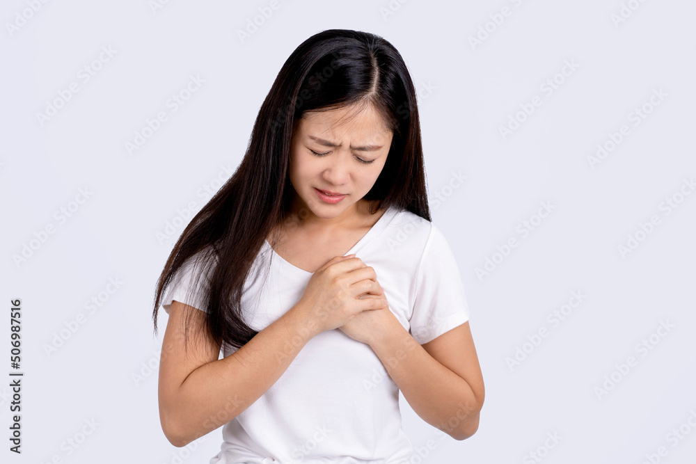 Portrait of asian woman was sick with chest pain standing isolated on white background. Portrait of asian woman was sick with chest pain standing isolated on white background.