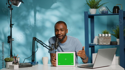 Obraz na plátně Black vlogger showing tablet with horizontal green screen on camera for podcast