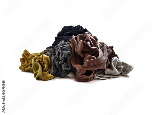 Piles of unwashed clothes on a white background.
