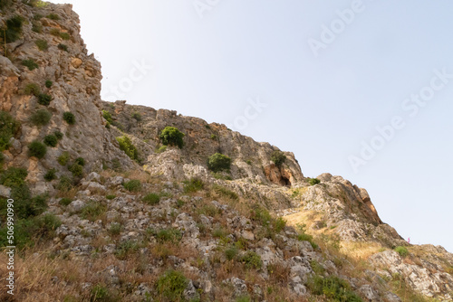 Overgrown with small crooked trees, grass and bushes, the slope of Mount Arbel, located on the shores of Lake Kinneret - the Sea of Galilee, near the city of Tiberias, in northern Israel.