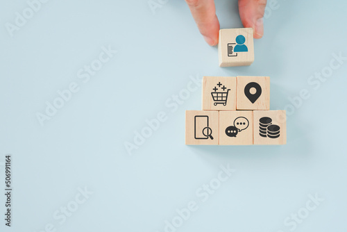 senior's hand holding wooden cubes with person with data icon on for buyer persona and target customer concept, buyer or customer psychology profile or characteristics