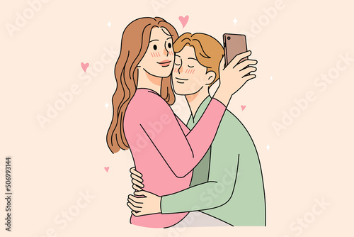 Happy couple cuddle take selfie together 