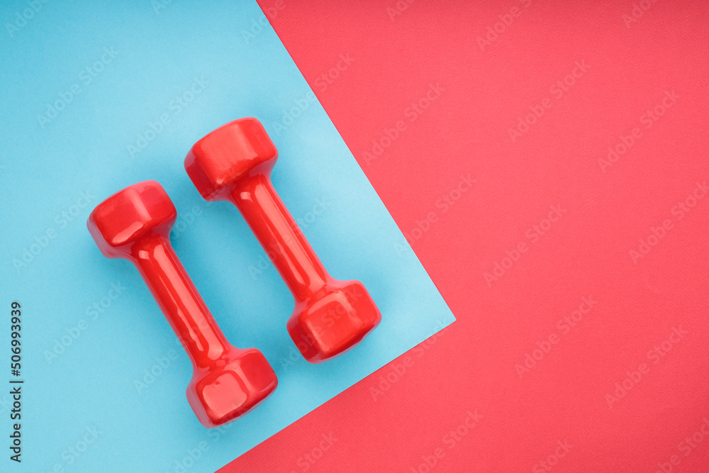 red and blue background on which there are dumbbells red and blue background on which there are dumbbells