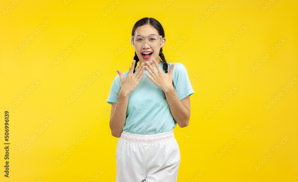 Photo of Surprised Young Asian Woman over isolated yellow background, summer concept Photo of Surprised Young Asian Woman over isolated yellow background, summer concept