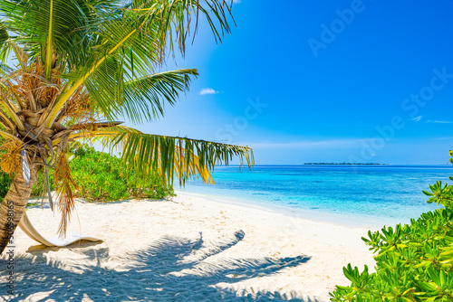 Shoreline of a tropical island in the Maldives and view of the Indian Ocean.