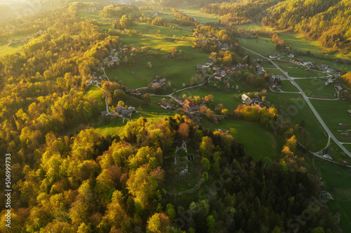 Aerial view of the fog in the valley of the countryside. Beautiful spring sunrise in Slovenia. 
