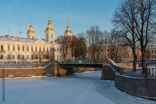 View of the Krasnogvardeysky Bridge over the Griboyedov Canal and the dome of the St. Nicholas Naval Cathedral on a sunny winter day, St. Petersburg, Russia