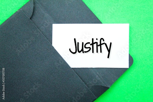 black envelope and white paper with the word Justify photo
