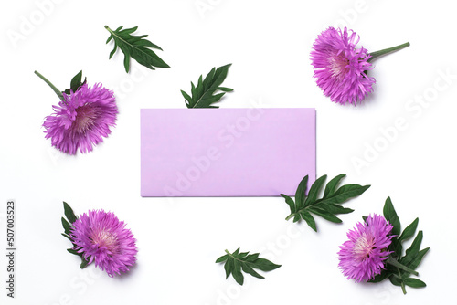 Invitation or greeting card mockup with blank lilac envelope with thistle flowers on white background photo