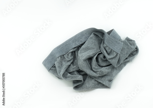 Isolated men's underwear on white background, throw away used underwear on the floor, top view image used men's underwear, gray color.