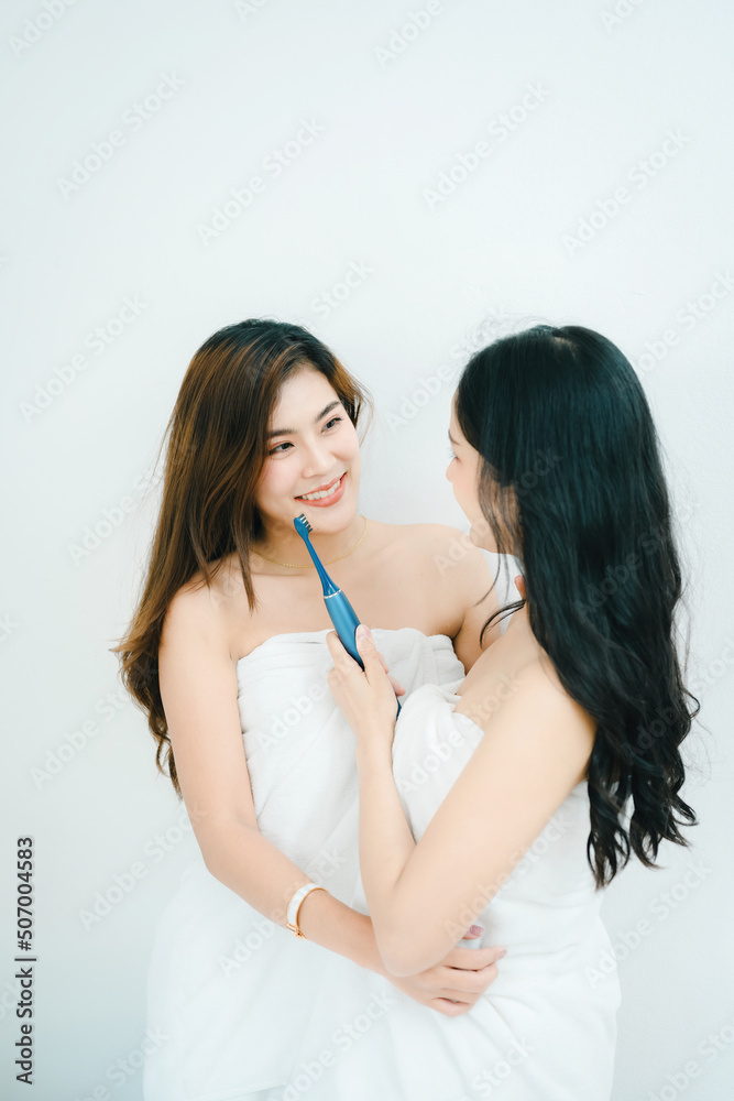 lgbtq, lgbt concept, homosexuality, portrait of two asian women posing happy together and showing love for each other while brushing teeth lgbtq, lgbt concept, homosexuality, portrait of two asian women posing happy together and showing love for each other while brushing teeth