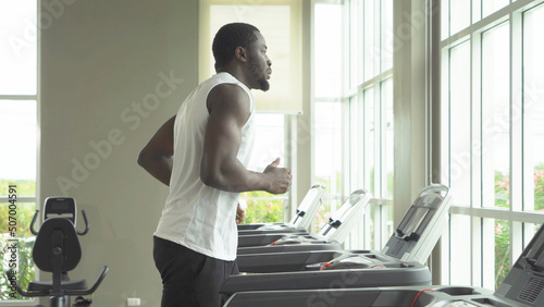 Black African american healthy man, person, running or jogging on treadmill, and training in gym or fitness center in sport and recreation concept. Lifestyle activity.