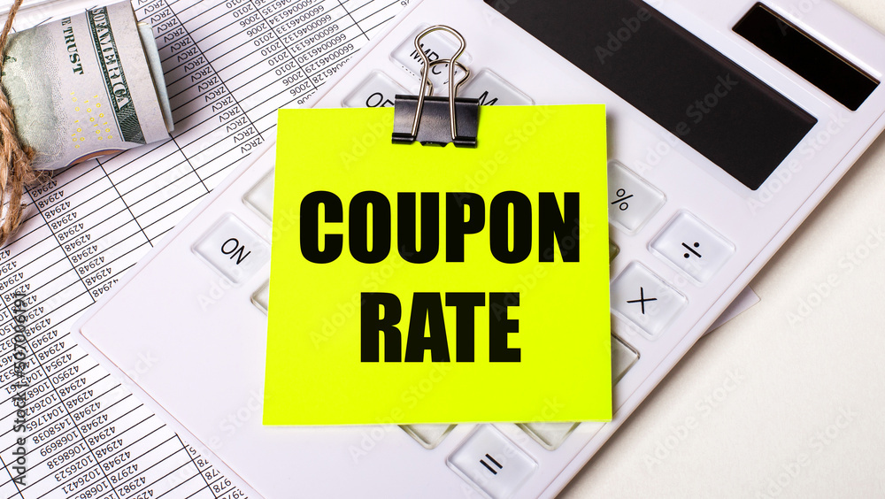 On a light background - cash, a white calculator and a yellow sticker under a black paper clip with the text COUPON RATE. Business concept On a light background - cash, a white calculator and a yellow sticker under a black paper clip with the text COUPON RATE. Business concept