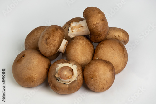 Raw portabella mushrooms on a white background