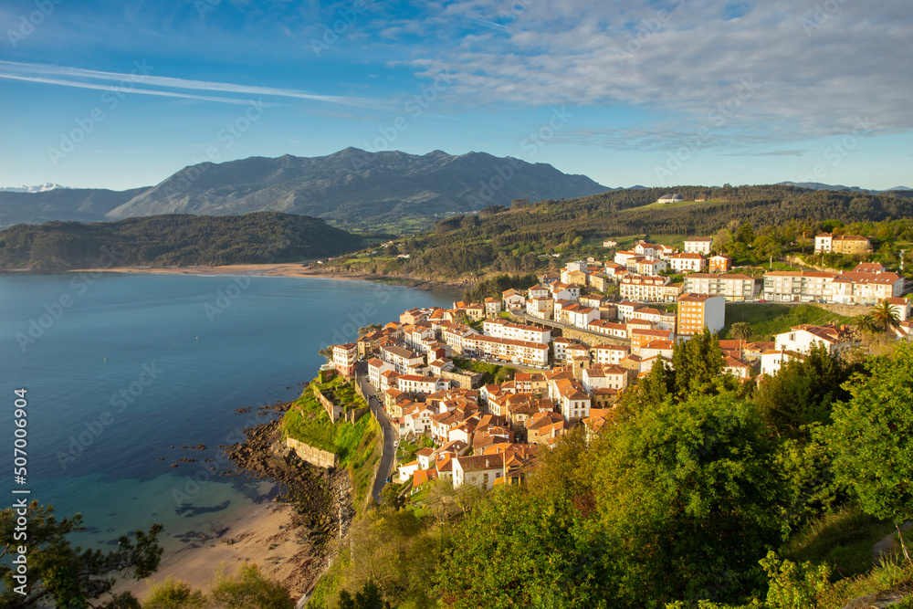 village of Lastres in Asturias, northern Spain. fishing village with the mountains in the background at sunrise. European tourism.