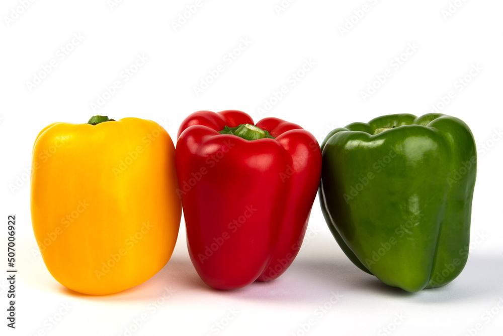 Yellow, red and green bell peppers on a white background Yellow, red and green bell peppers on a white background
